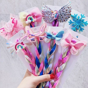 Detail of children's colorful braided hair extension with unicorn and rainbow motifs
