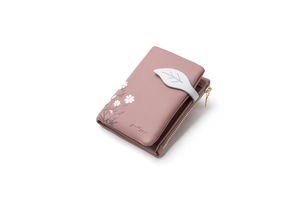 Detail of pink PU leather short wallet with leaf buckle and floral print on white background
