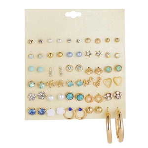 Detailed display of 30 pairs variety stud earrings set on a beige showcase card