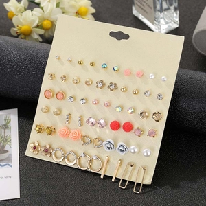 Detail of 30 pairs flower and rhinestone stud earring set on beige display card