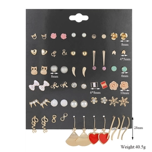 Detailed set of 30 pairs of gold-tone alloy stud earrings on black card display