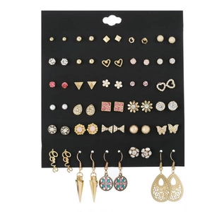 Detail of 30-pair earring set with crystals, pearls, and gold finish on display card