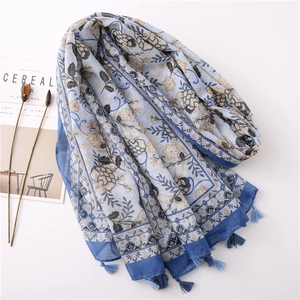 Detail of vintage floral cotton linen shawl featuring elegant blue fringe and botanical prints