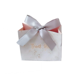 Elegant marble pattern gift bag with silver ribbon bow and Thank You gold lettering
