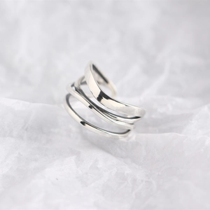 Macro shot of silver S925 sterling silver ring with minimalist multi-layered winding design