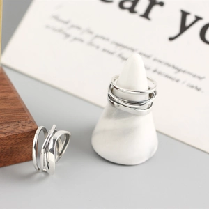Minimalist S925 sterling silver multilayer irregular winding rings on marble stand