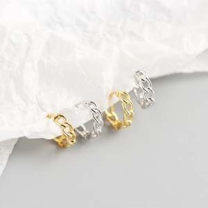 Macro view of S925 sterling silver Cuban chain hoop earrings in gold and silver finish