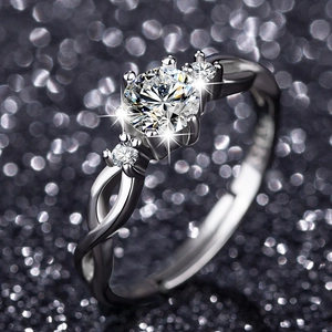 Detailed shot of three-stone zircon ring with twisted silver band and four-prong setting