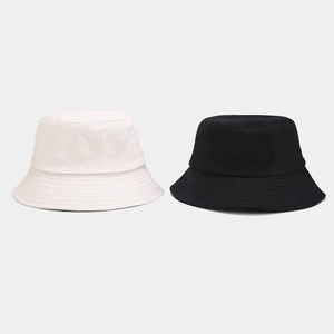 Detailed close-up of high-quality canvas bucket hats in classic black and white colors