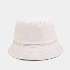 Close-up of a cream-white bucket hat showing high-density cotton twill fabric and stitching