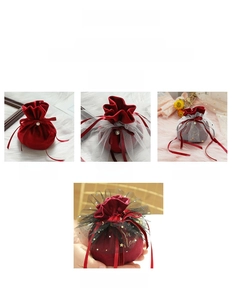 Detail of velvet wedding candy bags featuring pearl decorations and elegant ribbon ties