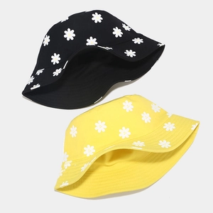 Floral bucket hat for women with white daisy print in yellow and black cotton fabric