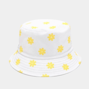 Close-up of white bucket hat with yellow daisy prints and breathable cotton fabric