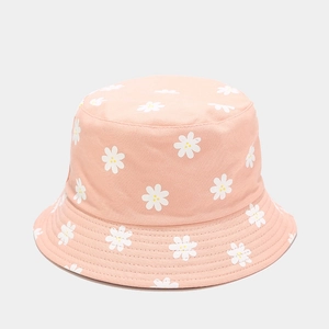 Close-up of peach pink bucket hat featuring white daisy prints and reinforced brim stitching