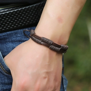 Men's vintage braided brown leather bracelet worn with casual style denim
