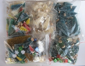 Macro shot of assorted mini sisal Christmas trees and festive ornaments in packaging