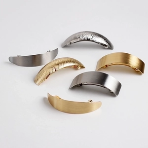 Minimalist gold and silver metal hair clips with brushed and textured matte finishes