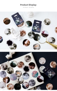 Detail view of round celestial stickers showing moon textures and starry sky art motifs