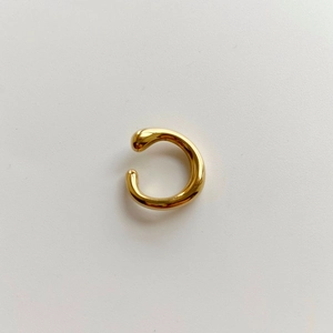 Detail of high-polish gold plated lava irregular ear cuff showing metallic texture