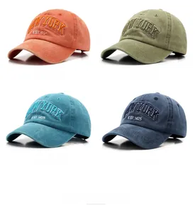 Detail view of New York embroidery on four colors of washed cotton baseball caps