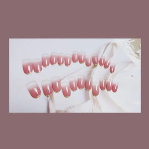 Pink gradient French press-on nails with gold glitter tips on elegant white lace background