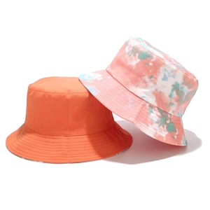 Fashionable tie-dye and solid orange reversible bucket hats for outdoor sun protection