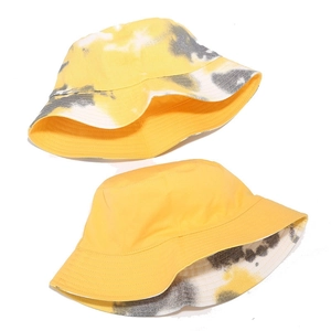 Double-sided tie-dye bucket hat with yellow and grey patterns and plain yellow reverse