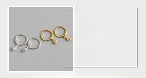 Detail view of S925 sterling silver hoop earrings with diamond rhombic charms