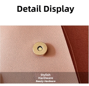 Detailed macro view of high-quality light gold magnetic clasp on pink pebbled leather