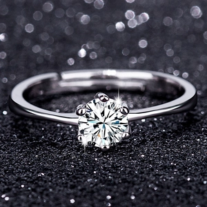 Macro shot of silver classic six-prong zircon ring with adjustable band on bokeh background
