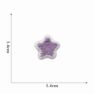 Detail view of a 1.4cm purple star embroidered patch with white border and texture