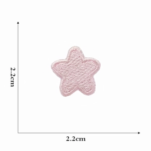 Detail showing pink star embroidery patch with 2.2cm dimensions on white background