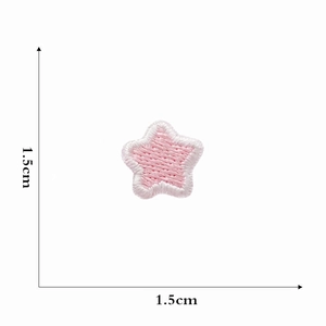 Detail shot of a small pink star embroidery patch with 1.5cm dimension measurement