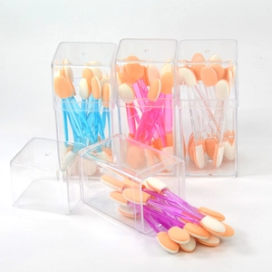Detail of disposable dual-sided sponge eyeshadow applicators in clear plastic storage boxes