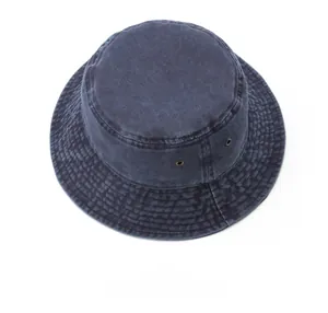 Detailed top view of a washed blue denim bucket hat with stitching and metal eyelets