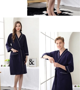 Detail of navy waffle robe featuring white contrast piping and textured moisture-wicking fabric