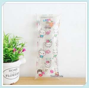 Detailed view of transparent PVC pouch with cartoon rabbit prints and metal snap closure