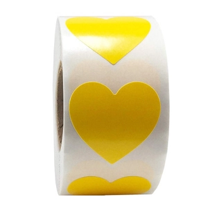 Close-up of a roll of yellow heart-shaped self-adhesive sticker labels for decoration