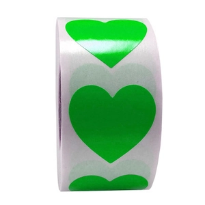Close-up of heart-shaped green adhesive stickers in a roll with glossy finish