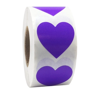 Detail view of a roll of purple heart shaped self-adhesive stickers for packaging
