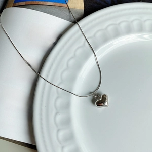 Macro view of a 925 sterling silver heart pendant on an octagonal snake chain