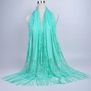 Detailed close-up of mint green lace shawl showing intricate floral patterns and fringe trim