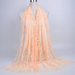 Detail of floral lace hollow pattern and fringe tassels on pink long scarf