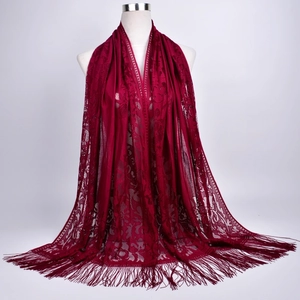 Close-up of wine red lace embroidery scarf with long decorative tassels and intricate patterns