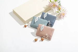 Short leather wallets for women featuring daisy prints and 3D leaf snap buttons