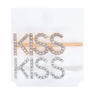 Detailed view of silver and gold KISS letter hair clips with sparkling crystal rhinestones