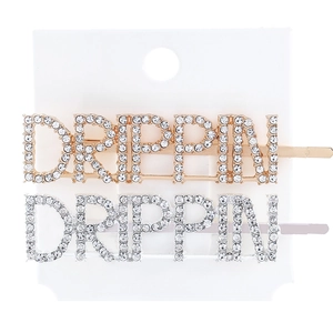 Macro shot of silver and gold DRIPPIN letter hair clips with white rhinestone inlay detail
