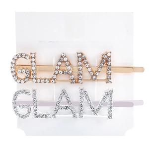 Detail of GLAM letter hair clips set with crystal rhinestones in gold and silver