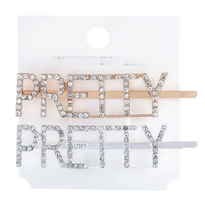 Close-up of gold and silver PRETTY letter hairpins with sparkling white rhinestones