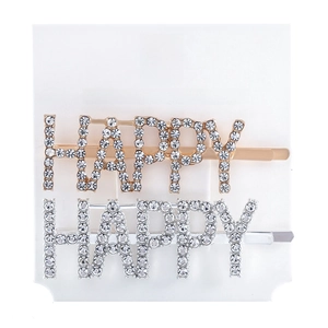 Detail of gold and silver hair clips featuring HAPPY rhinestone letters on white card